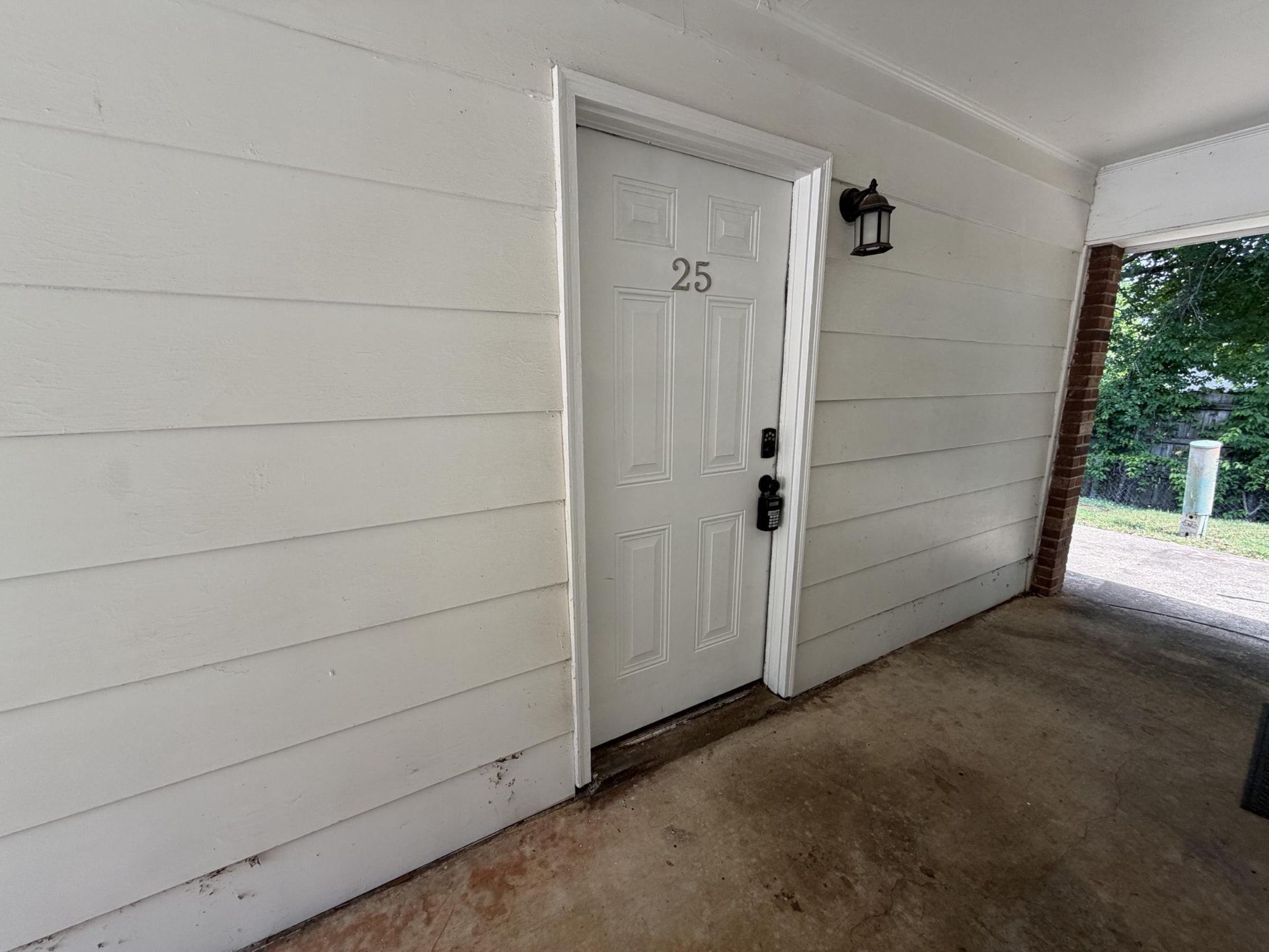 Apartment front door with keyless entry keypad at Creekside Apartments